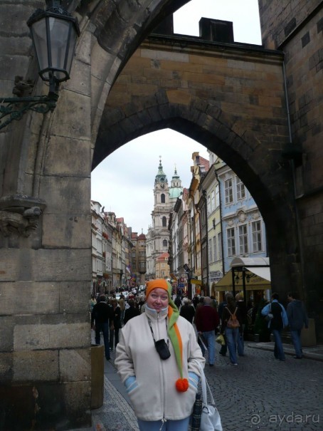 А впереди-то, между прочим, Карлов мост. Это его сторожевые башни маячат впереди. Вот я под ними стою, надев на себя шутовской колпак.

